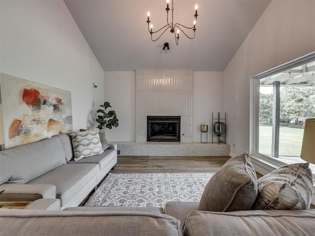 6401 Saddleback Dr, Oklahoma City, OK 73150 - living room featuring high vaulted ceiling, a chandelier, wood finished floors, and a fireplace