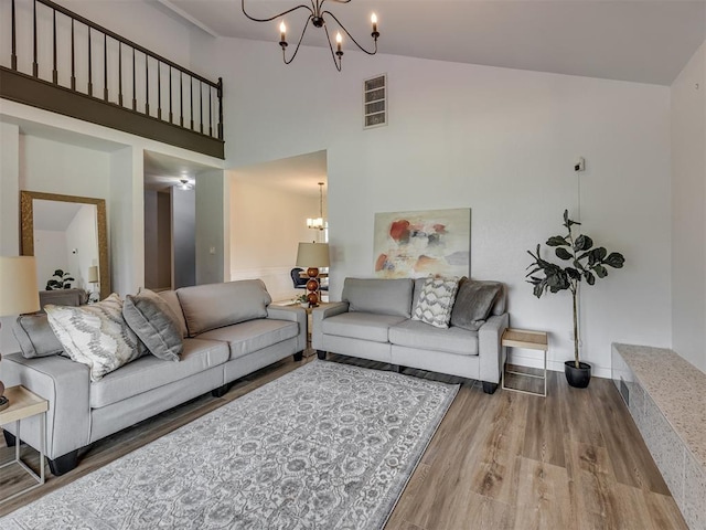 6401 Saddleback Dr, Oklahoma City, OK 73150 - living room featuring a chandelier, wood finished floors, and a high ceiling