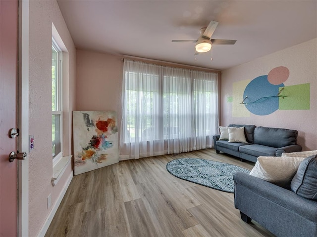 6401 Saddleback Dr, Oklahoma City, OK 73150 - living room with wood finished floors, ceiling fan, a textured wall, and baseboards
