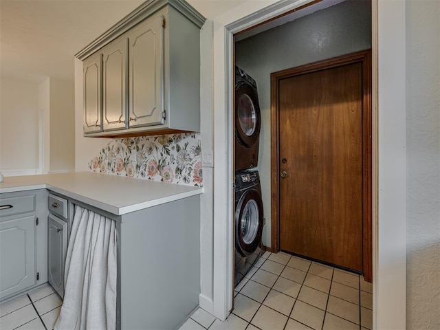 6401 Saddleback Dr, Oklahoma City, OK 73150 - laundry area with stacked washing machine and dryer and light tile patterned floors