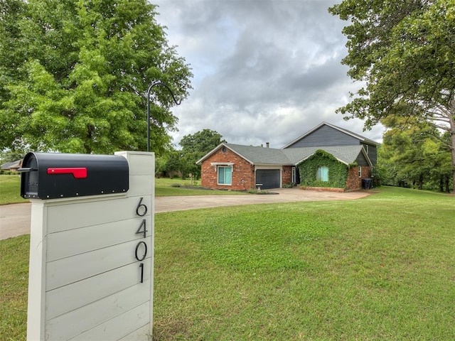 6401 Saddleback Dr, Oklahoma City, OK 73150 - single story home with concrete driveway, an attached garage, a front yard, and brick siding