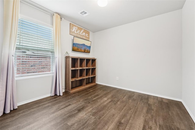 unfurnished room featuring wood finished floors and baseboards