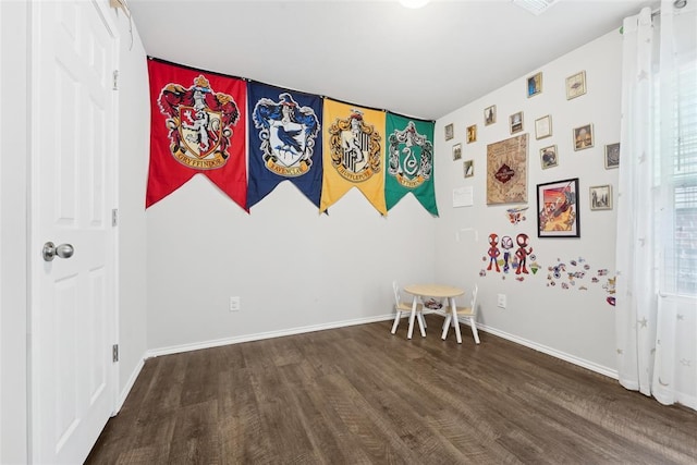 bedroom with wood finished floors and baseboards