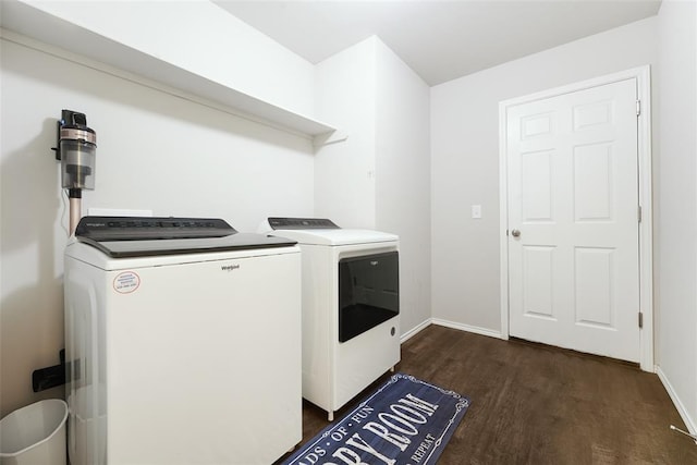washroom with washer and dryer, dark wood finished floors, and baseboards