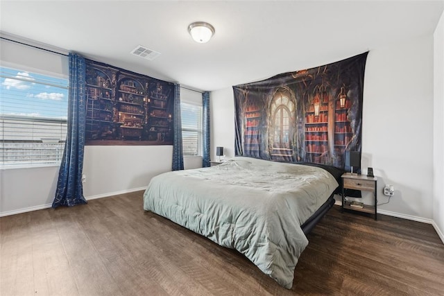 bedroom with wood finished floors and baseboards