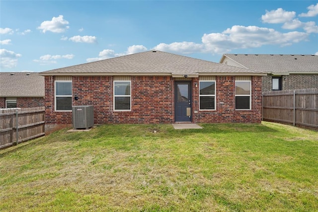 rear view of property with central air condition unit, brick siding, and roof with shingles