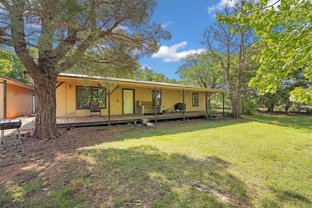 11402 N 1957th Rd, Elk City, OK 73644 - rear view of house with a yard, metal roof, and a deck