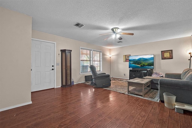 11402 N 1957th Rd, Elk City, OK 73644 - living area with a ceiling fan, wood finished floors, a textured ceiling, and baseboards