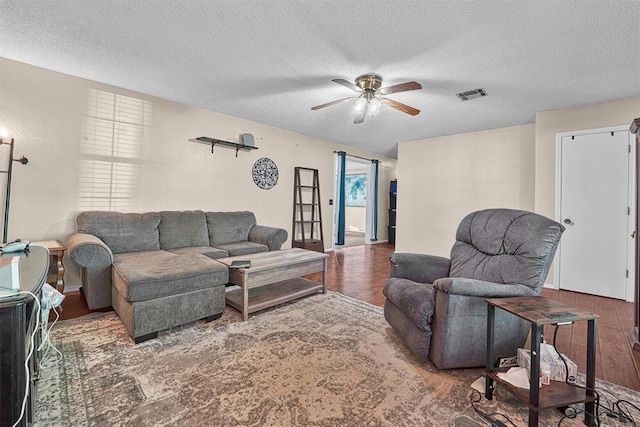 11402 N 1957th Rd, Elk City, OK 73644 - living room featuring wood finished floors, a ceiling fan, and a textured ceiling