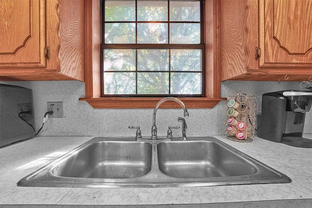 11402 N 1957th Rd, Elk City, OK 73644 - kitchen view of a sink, light countertops, and brown cabinetry