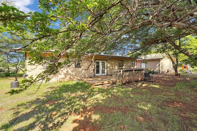 11402 N 1957th Rd, Elk City, OK 73644 - back of property with french doors, a deck, a yard, and stucco siding