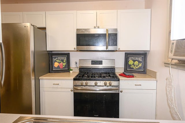 kitchen with stainless steel appliances, white cabinetry, and light countertops
