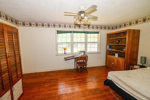 bedroom with wood finished floors and baseboards