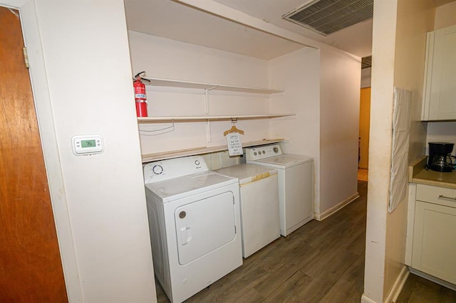 washroom with washing machine and dryer and wood finished floors