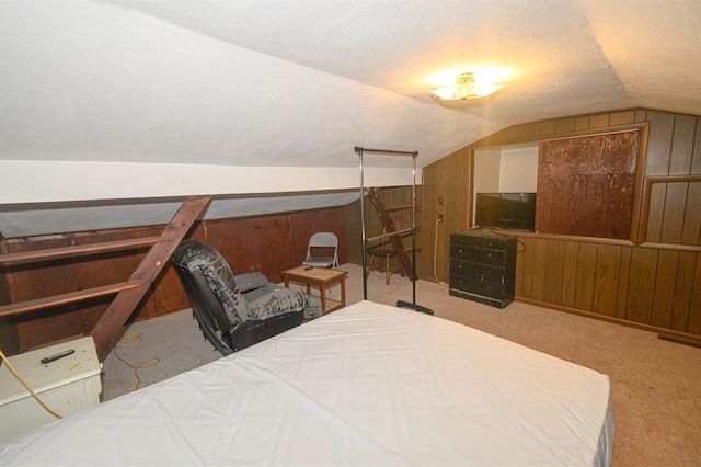 bedroom featuring lofted ceiling, carpet flooring, and wood walls