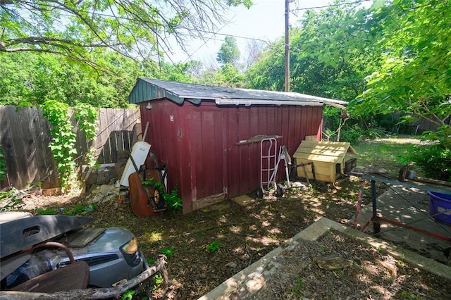 view of shed featuring fence