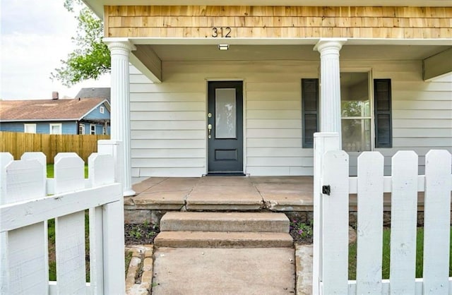 312 S Ash St, Guthrie, OK 73044 - entrance to property featuring a porch and fence
