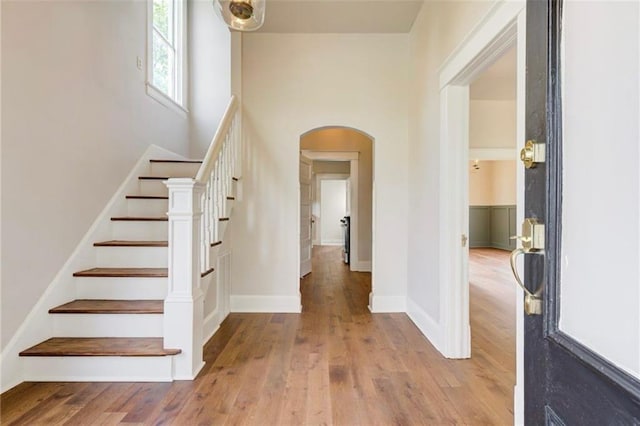 312 S Ash St, Guthrie, OK 73044 - entrance foyer with arched walkways, wood finished floors, stairway, and baseboards