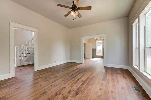 312 S Ash St, Guthrie, OK 73044 - unfurnished room featuring stairs, wood finished floors, baseboards, and ceiling fan