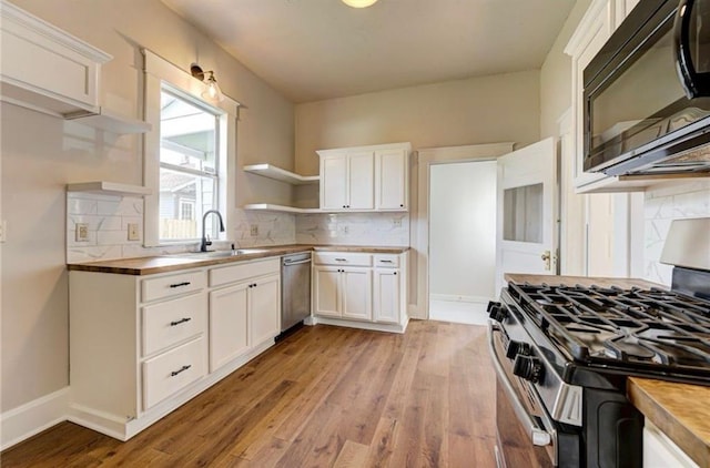 312 S Ash St, Guthrie, OK 73044 - kitchen with appliances with stainless steel finishes, a sink, wooden counters, and open shelves
