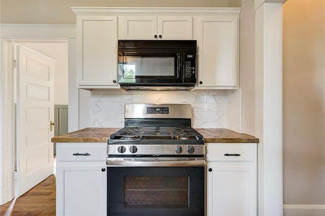 312 S Ash St, Guthrie, OK 73044 - kitchen with black microwave, stainless steel range with gas cooktop, backsplash, and wood finished floors