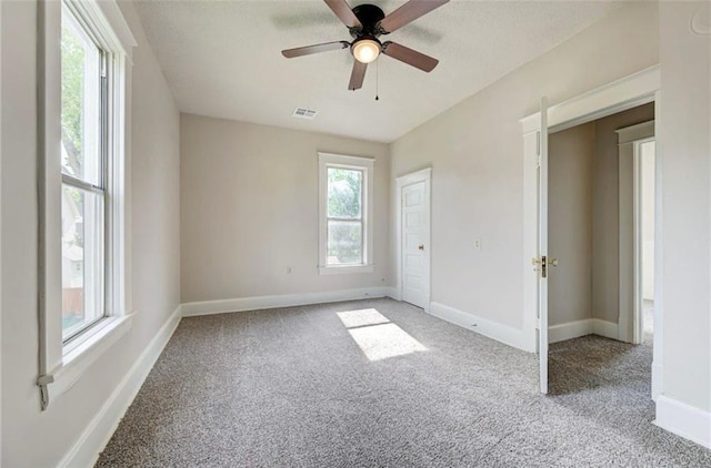 312 S Ash St, Guthrie, OK 73044 - unfurnished bedroom featuring light carpet, baseboards, and ceiling fan