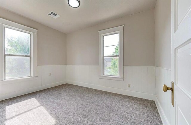 312 S Ash St, Guthrie, OK 73044 - empty room featuring carpet flooring and wainscoting