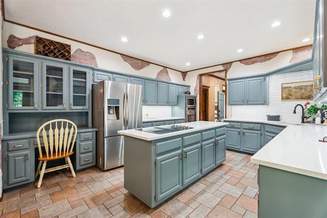 kitchen with stainless steel appliances, a center island, backsplash, light countertops, and recessed lighting