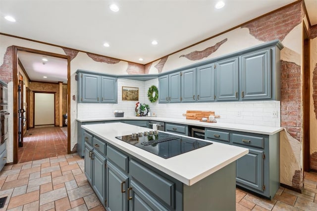 kitchen with black electric stovetop, light countertops, a center island, backsplash, and recessed lighting