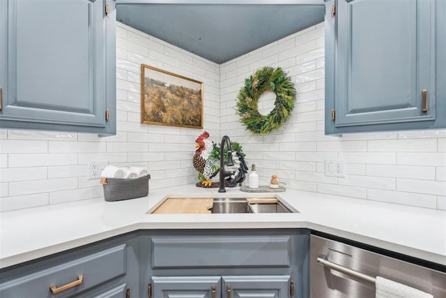 kitchen featuring a sink, stainless steel dishwasher, light countertops, and backsplash