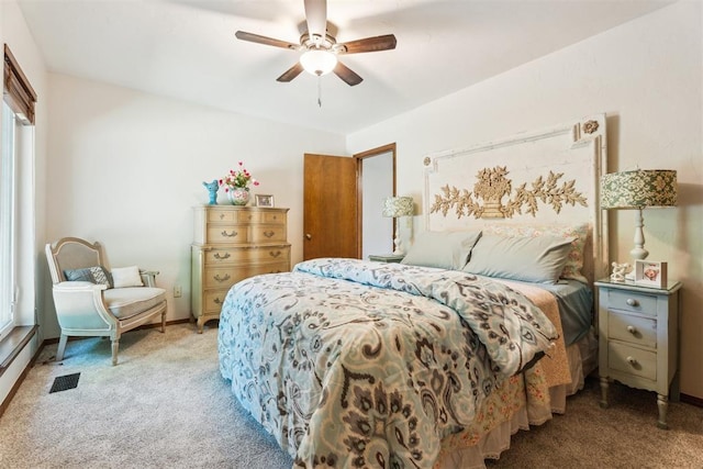 carpeted bedroom with baseboards, a ceiling fan, and multiple windows