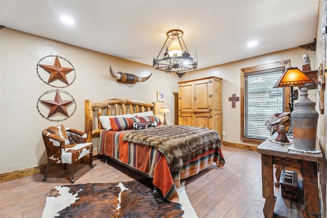 bedroom with baseboards, light wood-style floors, and recessed lighting
