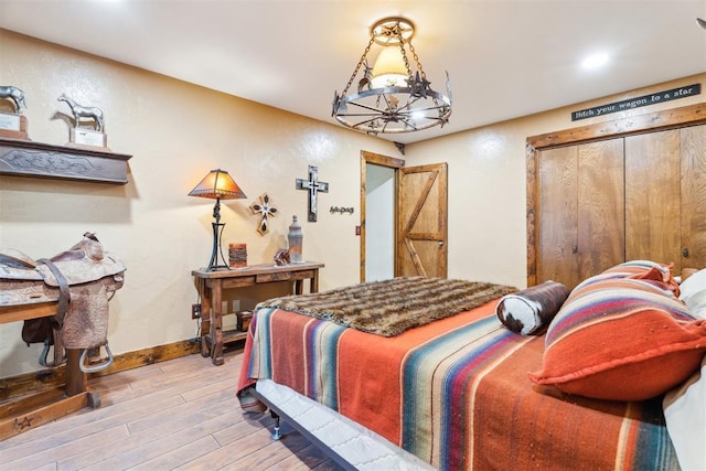 bedroom with wood finished floors, baseboards, and recessed lighting