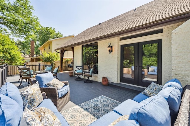 view of patio with french doors, an outdoor living space, fence, and a deck