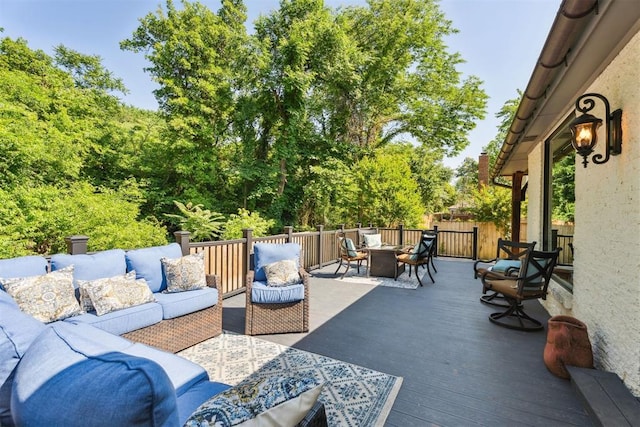 view of patio / terrace with outdoor lounge area, a wooden deck, and fence