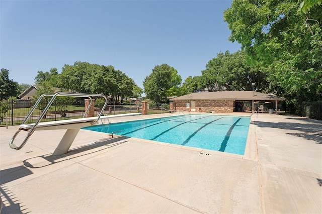 community pool featuring fence and a patio