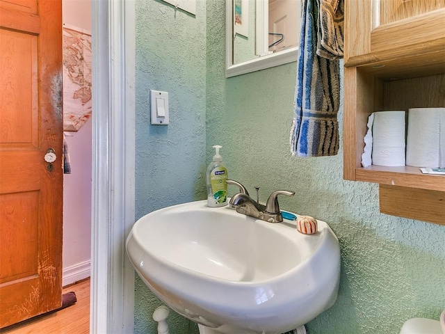 2321 Cashion Pl, Oklahoma City, OK 73112 - bathroom with wood finished floors, a sink, and a textured wall
