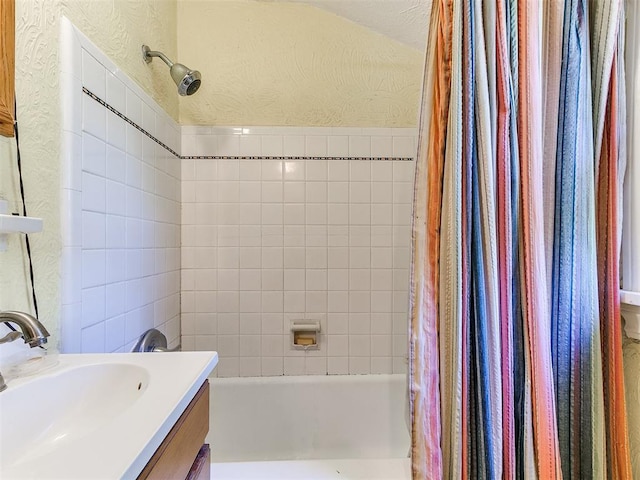 2321 Cashion Pl, Oklahoma City, OK 73112 - bathroom featuring shower / tub combo, a textured wall, and vanity