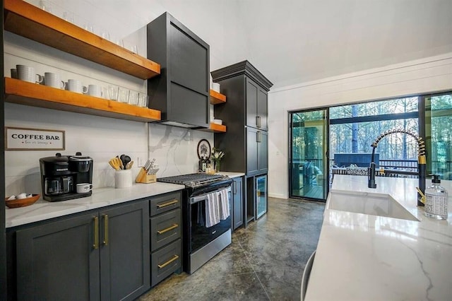 2427 Camp Ranch Rd, Broken Bow, OK 74728 - kitchen featuring open shelves, stainless steel gas range, finished concrete floors, a sink, and beverage cooler