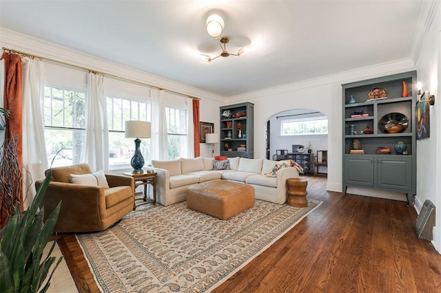 living area with arched walkways, dark wood-type flooring, and ornamental molding