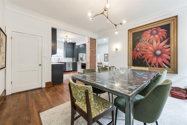 dining room featuring a chandelier, crown molding, and dark wood-style floors