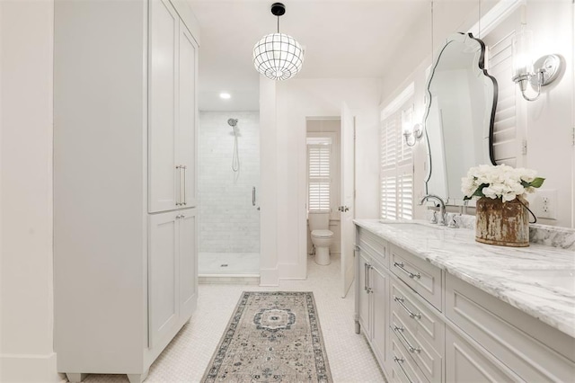 full bath featuring a shower stall, vanity, and toilet