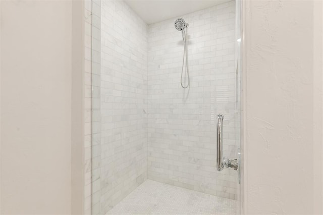 full bath with a tile shower