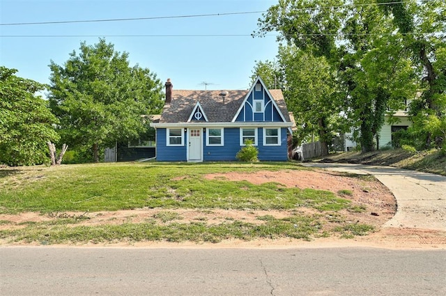 1706 E Oklahoma Ave, Guthrie, OK 73044 - tudor home featuring a chimney and a front lawn