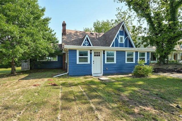 1706 E Oklahoma Ave, Guthrie, OK 73044 - rear view of property featuring a lawn and a chimney