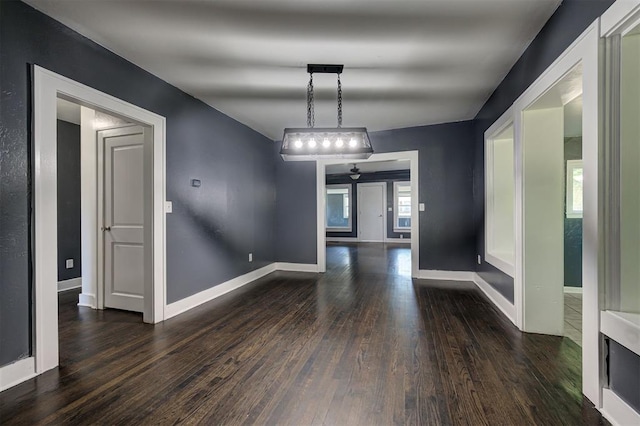 1706 E Oklahoma Ave, Guthrie, OK 73044 - unfurnished dining area with dark wood-style flooring and baseboards