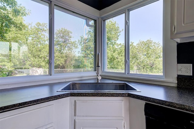 1706 E Oklahoma Ave, Guthrie, OK 73044 - kitchen with a sink, dishwashing machine, and white cabinets