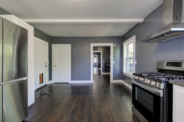 1706 E Oklahoma Ave, Guthrie, OK 73044 - kitchen with appliances with stainless steel finishes, wall chimney exhaust hood, dark wood-style flooring, white cabinetry, and baseboards