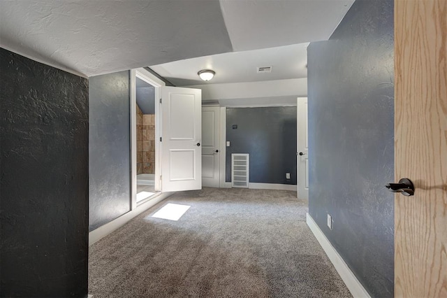 1706 E Oklahoma Ave, Guthrie, OK 73044 - unfurnished room featuring carpet, a textured wall, and baseboards