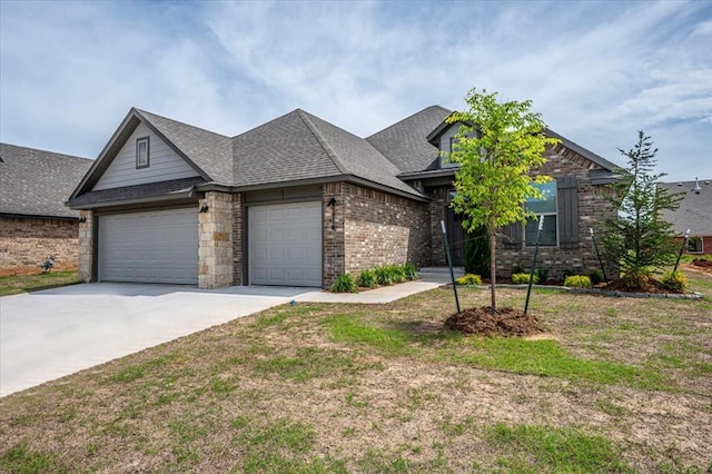 view of front of property featuring a garage, concrete driveway, brick siding, and roof with shingles